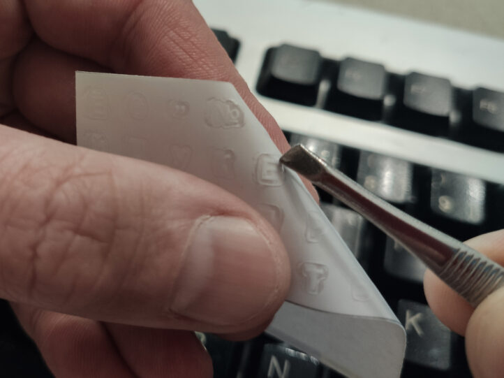 Наклейки на клавіатуру на прозорому фоні з українськими літерами вирізані по контуру